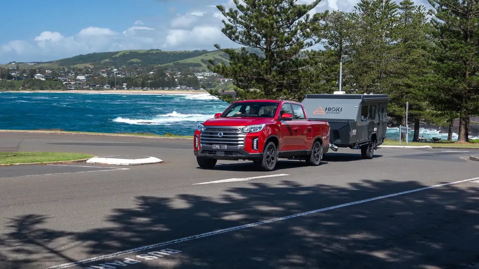 KGM Musso towing a caravan down a beach side road